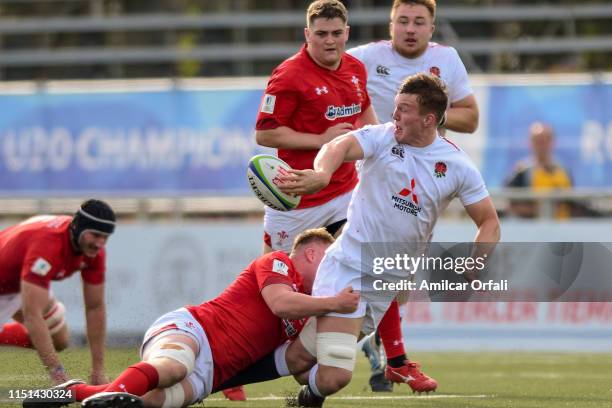 Joe Heyes of England U20 passes the ball while being tackled during a Fifth place play-off match between England U20 and Wales U20 as part of World...