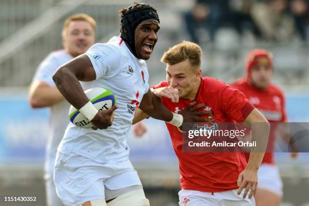 Joel Kpoku of England U20 hands off Harri Morgan of Wales U20 during a Fifth place play-off match between England U20 and Wales U20 as part of World...