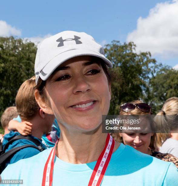 Crown Princess Mary of Denmark speaks to the press after finishing her run at the relay run for children held by The Mary Foundation and Save The...