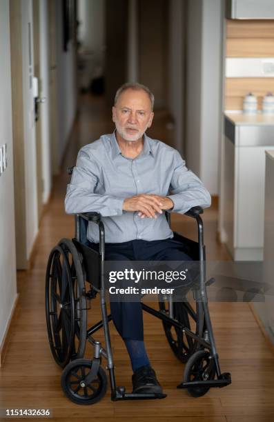 disabled senior man in a wheelchair at home - diabetic amputation stock pictures, royalty-free photos & images