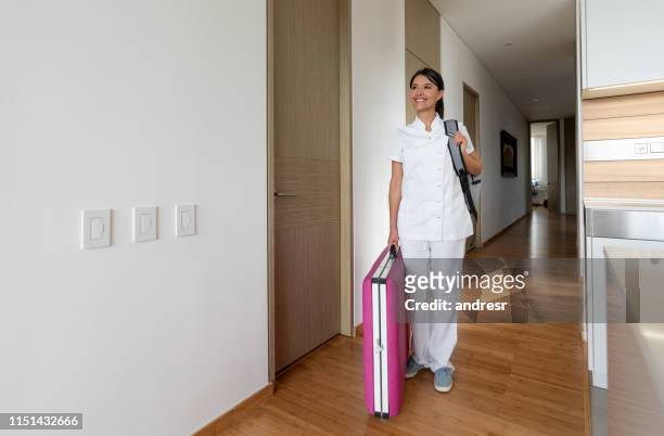 happy masseuse arriving at a client's house - beautician stock pictures, royalty-free photos & images