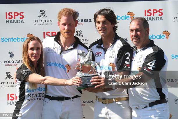 Sarah Siegel Magness, Harry, Duke of Sussex, Nacho Figueras and Michael Carrazza of Team Sentebale St Regis, celebrate victory with the trophy after...