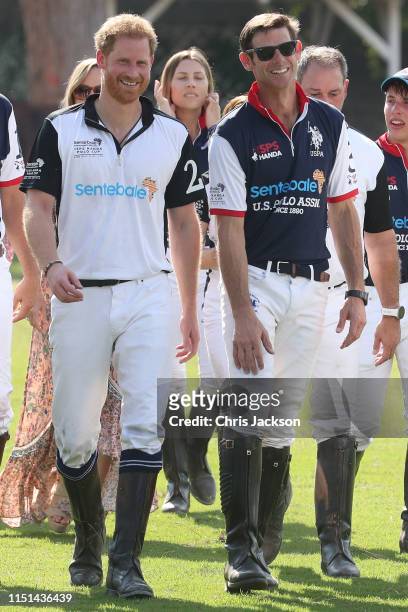 Harry, Duke of Sussex of Team Sentebale St Regis and Malcolm Borwick of Team US Polo Assn, chat after the Sentebale ISPS Handa Polo Cup between Team...