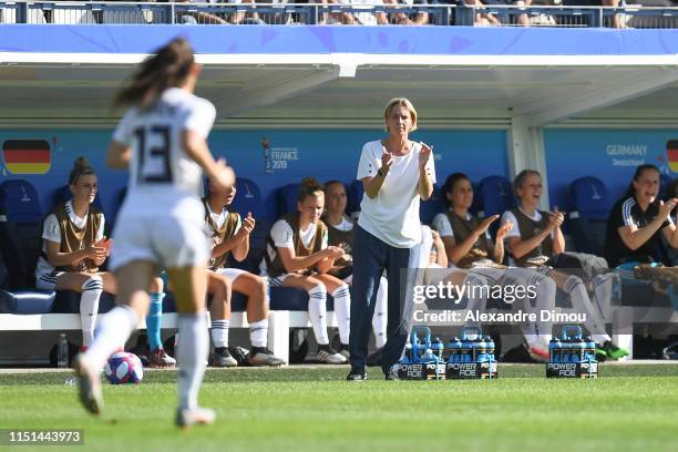 Martina Voss Tecklenburg head coach of Germany celebrates the second scoring with team mates during the Women's World Cup match between Germany and...