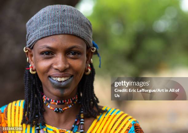 Portrait of a Peul tribe woman with tattooed lips, Savanes district, Boundiali, Ivory Coast on May 3, 2019 in Boundiali, Ivory Coast.