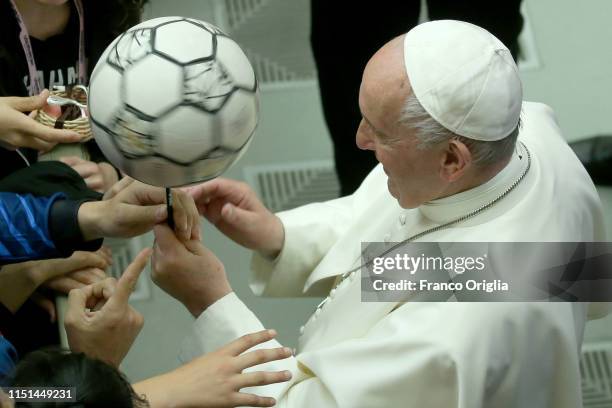 Pope Francis plays with a ball during an audience to the Italian Football Federation at the Pail VI Hall on May 24, 2019 in Vatican City, Vatican....