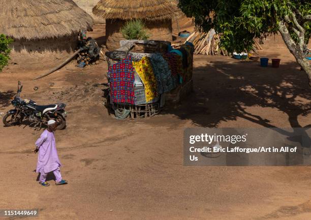 African muslim man walking in a village, Denguélé, Korondougou, Ivory Coast on May 5, 2019 in Korondougou, Ivory Coast.