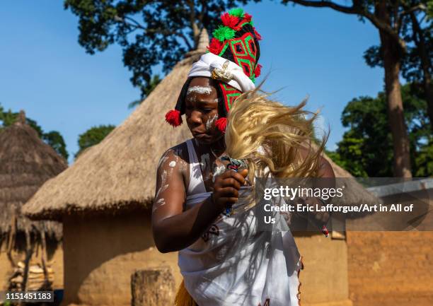 Dan tribe woman with a headdress dancing during a ceremony, Bafing, Gboni, Ivory Coast on May 5, 2019 in Gboni, Ivory Coast.