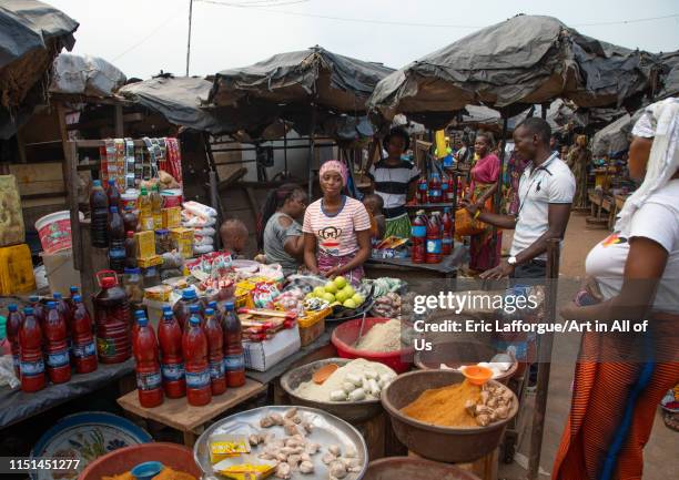 African woman selling on a local market, Tonkpi Region, Man, Ivory Coast on May 6, 2019 in Man, Ivory Coast.