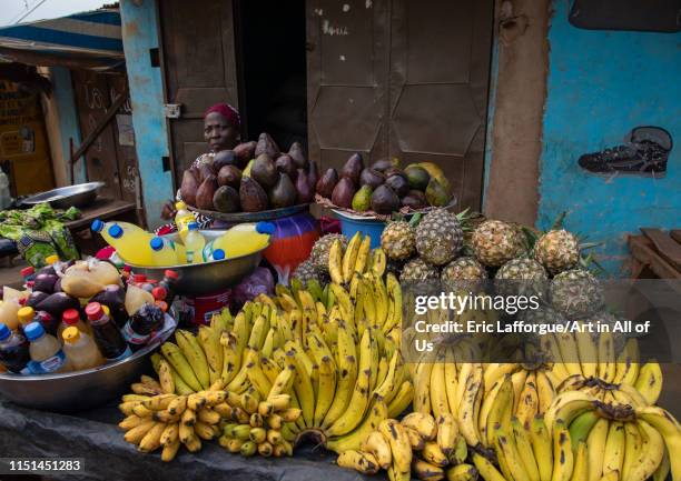 African woman selling fruits and vegetables on a local market, Tonkpi Region, Man, Ivory Coast on May 6, 2019 in Man, Ivory Coast.