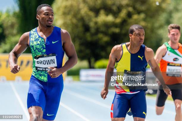 Aaron Brown and Thando Roto cross the finishing line in the men's 100m heat race during the Riunione Italiana di Velocità athletic meeting in Rieti,...