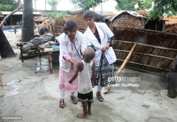 Indian local doctors checks the symptoms of AES to a child of Harvansh pur village, vaishali District , some 35 kms from MuzaffarPur , Bihar on June...