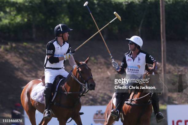 Harry, Duke of Sussex and Nacho Figueras, St. Regis Connoisseur and Sentebale Ambassdor celebrate during the Sentebale ISPS Handa Polo Cup between...