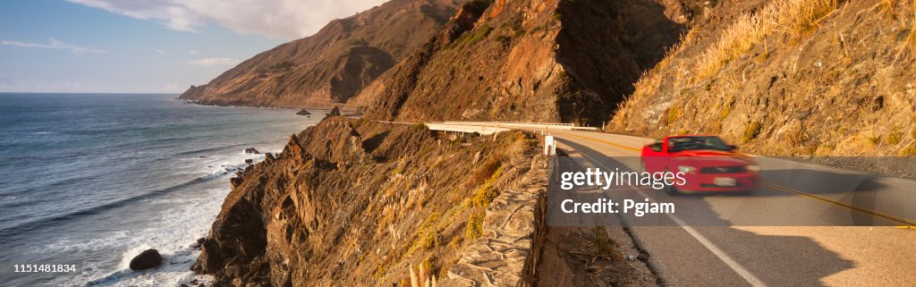 Convertible car journeys down the Big Sur coast panorama in California USA