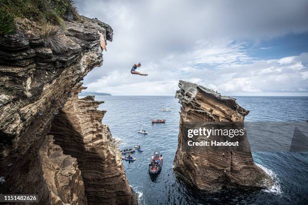 In this handout image provided by Red Bull, Rhiannan Iffland of Australia dives from a 21 metre cliff at the Snakehead on Islet Vila Franco do Campo...