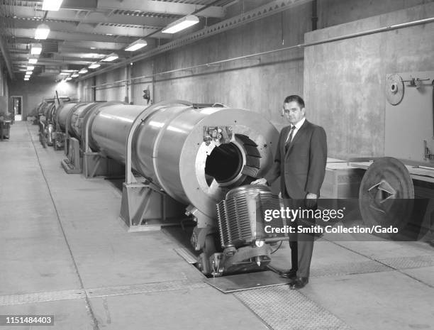 Branch Chief Thomas Canning stands beside a Hypersonic Free-Flight Aerodynamic Facility combustion-driven shock tube at Ames Research Center,...