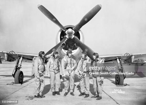 Langley research pilots Mel Gough, Herb Hoover, Jack Reeder, Steve Cavallo and Bill Gray stand in front of a P-47 Thunderbolt Fighter at Langley...