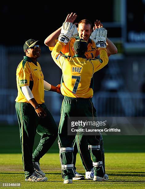 Andy Carter of Nottinghamshire celebrates with Chris Read after capturing the wicket of Greg Smith of Derbyshire during the Friends Life T20 match...
