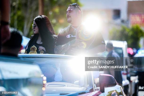 Heavyweight boxing champion Andy Ruiz Jr. And his wife Julie Ruiz wave to supporters during a parade in his honor on Saturday, June 22, 2019 in...