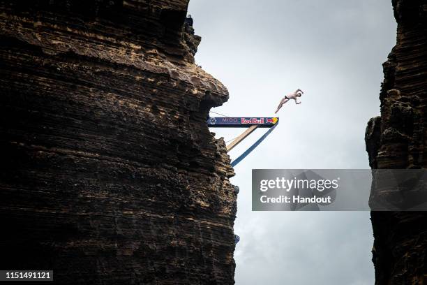 In this handout image provided by Red Bull, Andy Jones of the USA dives from the 27 metre platform at Islet Vila Franca do Campo during the final...