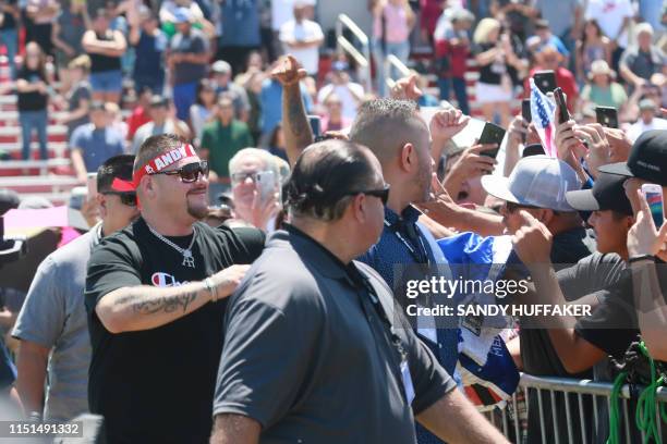 Heavyweight boxing champion Andy Ruiz Jr. Waves to supporters during a homecoming parade on June 22, 2019 in Imperial, California. - Boxer Andy Ruiz...