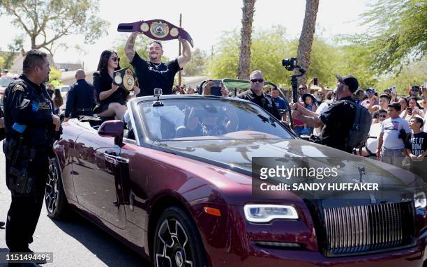 Heavyweight boxing champion Andy Ruiz Jr. And his wife Julie wave to supporters during a parade in his honour on June 22, 2019 in Imperial,...