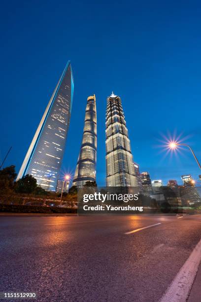 city traffic at night in shanghai - jin mao tower stock pictures, royalty-free photos & images