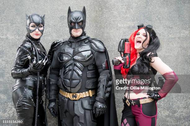 Cosplayers in character as Catwoman, Batman and Haley Quinn during Day 1 of London MCM Comic Con 2019 at ExCel on May 24, 2019 in London, England.