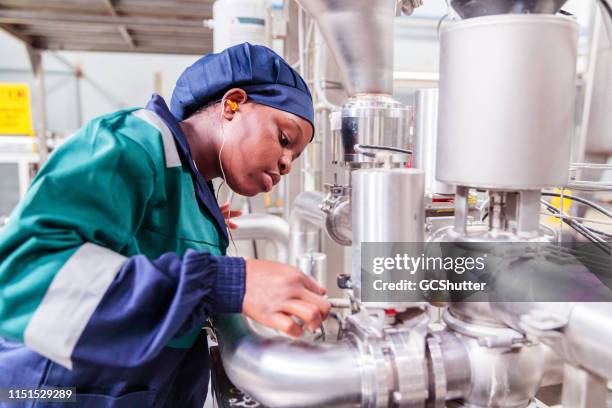african female factory worker checking the gauge - lusaka stock pictures, royalty-free photos & images