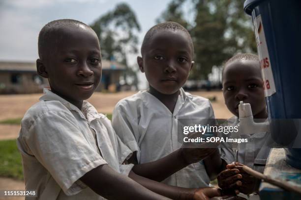 Children wash their hands with chlorinated water at a primary school as part of a preventive initiative aimed at halting the spread of Ebola in Beni....