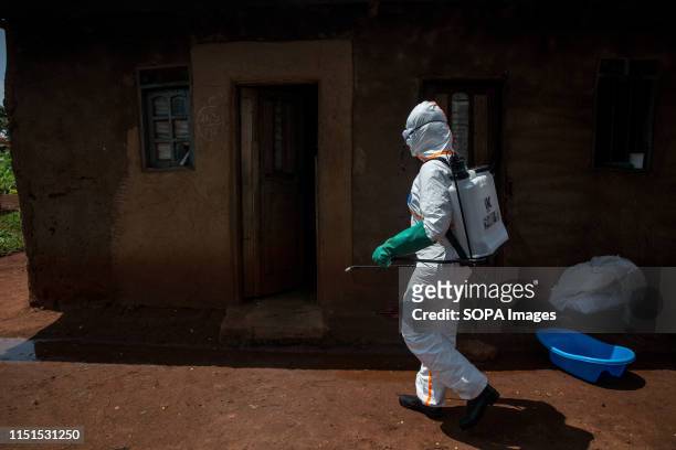 World Health Organization worker Belinda Landu decontaminates the house of a pastor who has just tested positive for Ebola in Beni. The DRC is...