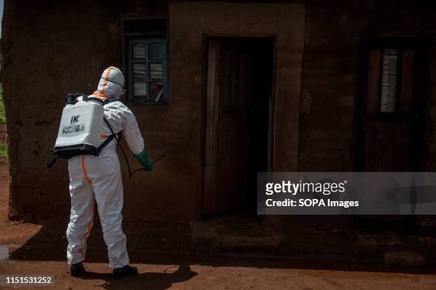 World Health Organization worker Belinda Landu decontaminates the house of a pastor who has just tested positive for Ebola in Beni. The DRC is...