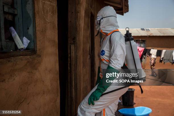 World Health Organization worker Belinda Landu decontaminates the house of a pastor who has just tested positive for Ebola in Beni. The DRC is...