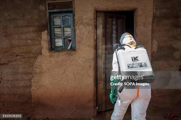 World Health Organization worker Belinda Landu decontaminates the house of a pastor who has just tested positive for Ebola in Beni. The DRC is...