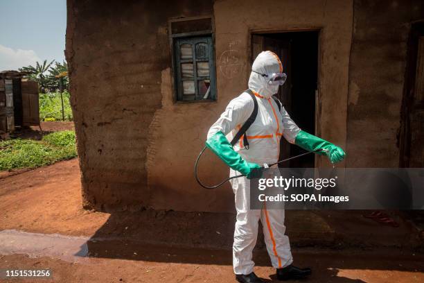 World Health Organization worker Belinda Landu decontaminates the house of a pastor who has just tested positive for Ebola in Beni. The DRC is...