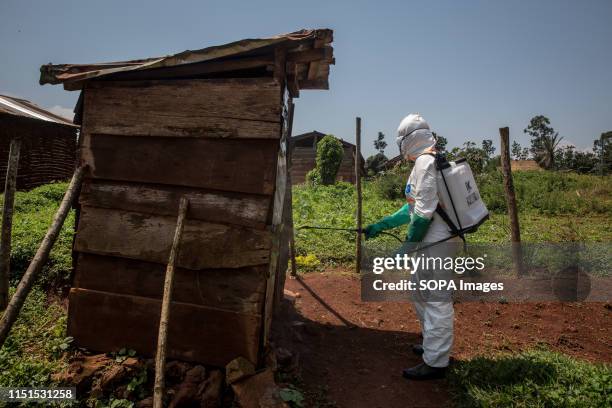 World Health Organization worker Belinda Landu decontaminates the house of a pastor who has just tested positive for Ebola in Beni. The DRC is...