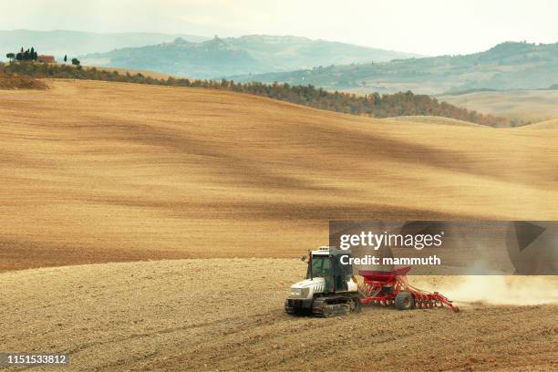 caterpillar tractor pulling seeder and harrow - harrow agricultural equipment stock pictures, royalty-free photos & images