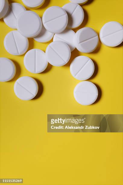 white pills, painkillers on a yellow background. layout for special offers as advertising, web background. the concept of medicine, pharmacy and healthcare. analgesic. copy space for text - aspirina imagens e fotografias de stock