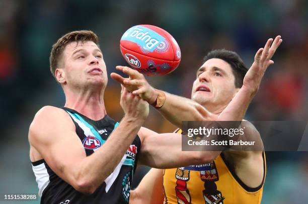 Peter Ladhams of the Power and Marc Pittonet of the Hawks compete for the ball during the round 10 AFL match between the Hawthorn Hawks and the Port...