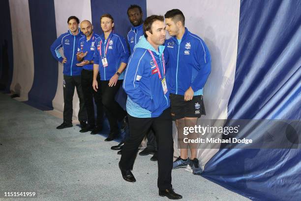 An emotional Kangaroos head coach Brad Scott is seen after his win walking past staff and players during the round 10 AFL match between the Western...