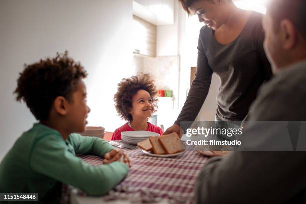 family mornings at home - boy pajamas cereal stock pictures, royalty-free photos & images