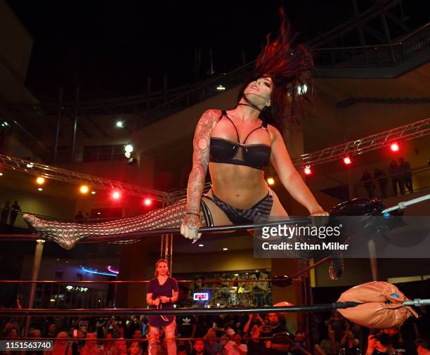 Fighter Katie "The Bombshell" Forbes climbs on top of the ropes as she is introduced before her match against Sheila "Crash" Cardinal during...
