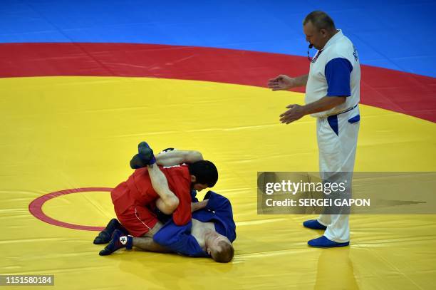 Azerbaijan's Aghasif Samadov competes against Lithuania's Gintaras Katkus in the mens sambo under 52 kg category quarterfinal bout at the 2019...