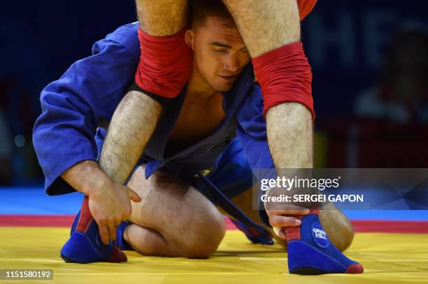 Armenia's Arsen Ghazaryan competes against Russia's Stanislav Skryabin in the mens sambo under 74 kg category quarterfinal bout at the 2019 European...