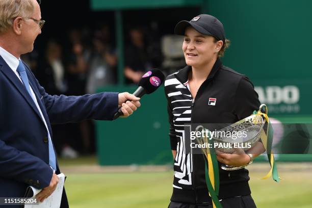 Australia's Ashleigh Barty gives an on-court interview after collecting the trophy after her straight sets victory over Germany's Julia Gorges in...