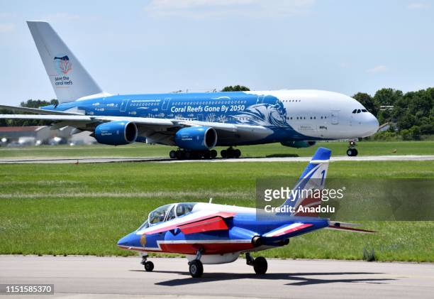 An Airbus A380 and an Alpha jets of the French Air Force Patrouille de France are taxiing down the runway during the 53rd International Paris Air...