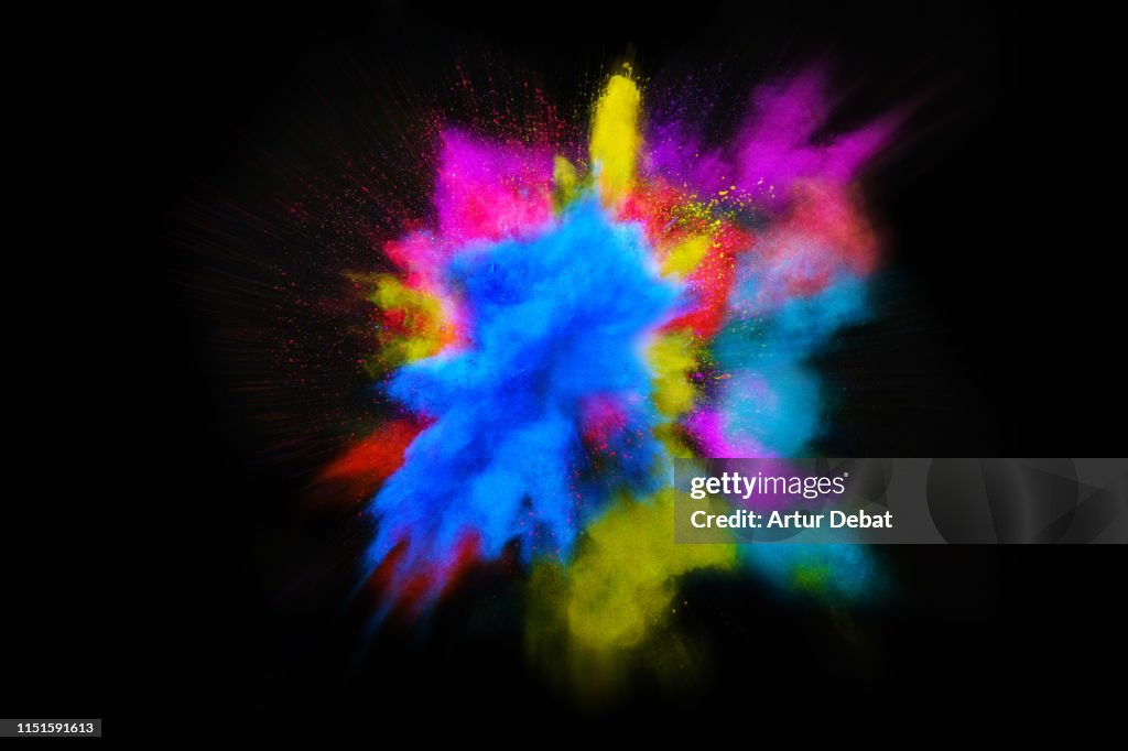 Beautiful powder explosion in all directions with vivid colors and black background.