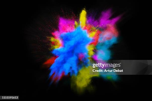 beautiful powder explosion in all directions with vivid colors and black background. - star burst imagens e fotografias de stock