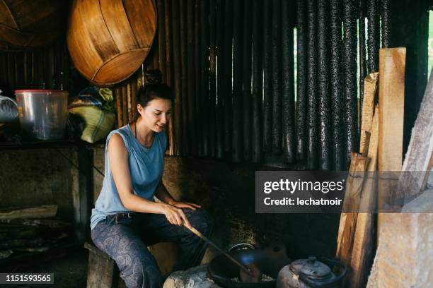 young woman roasting balinese coffee - civet coffee in indonesia stock pictures, royalty-free photos & images