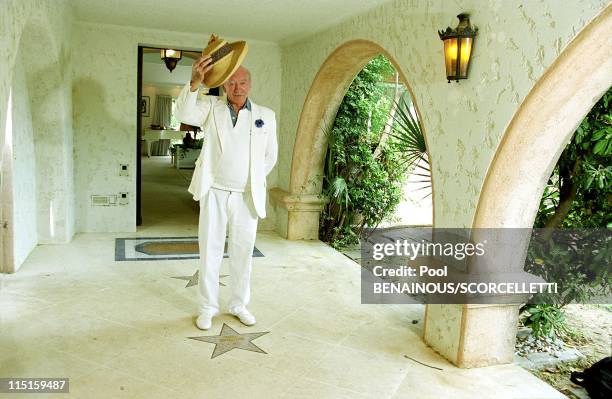 Eddie Barclay in his house with Elodie in Saint Tropez, France on July 25, 2000.